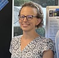 Katie Travis in front of poster