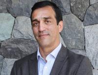Mauricio headshot in front of slate wall