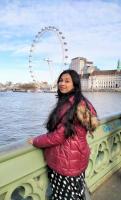 Samiha by the water and a ferris wheel