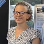 Katie Travis in front of poster