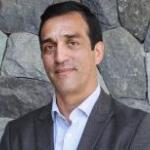 Mauricio headshot in front of slate wall