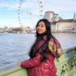 Samiha by the water and a ferris wheel